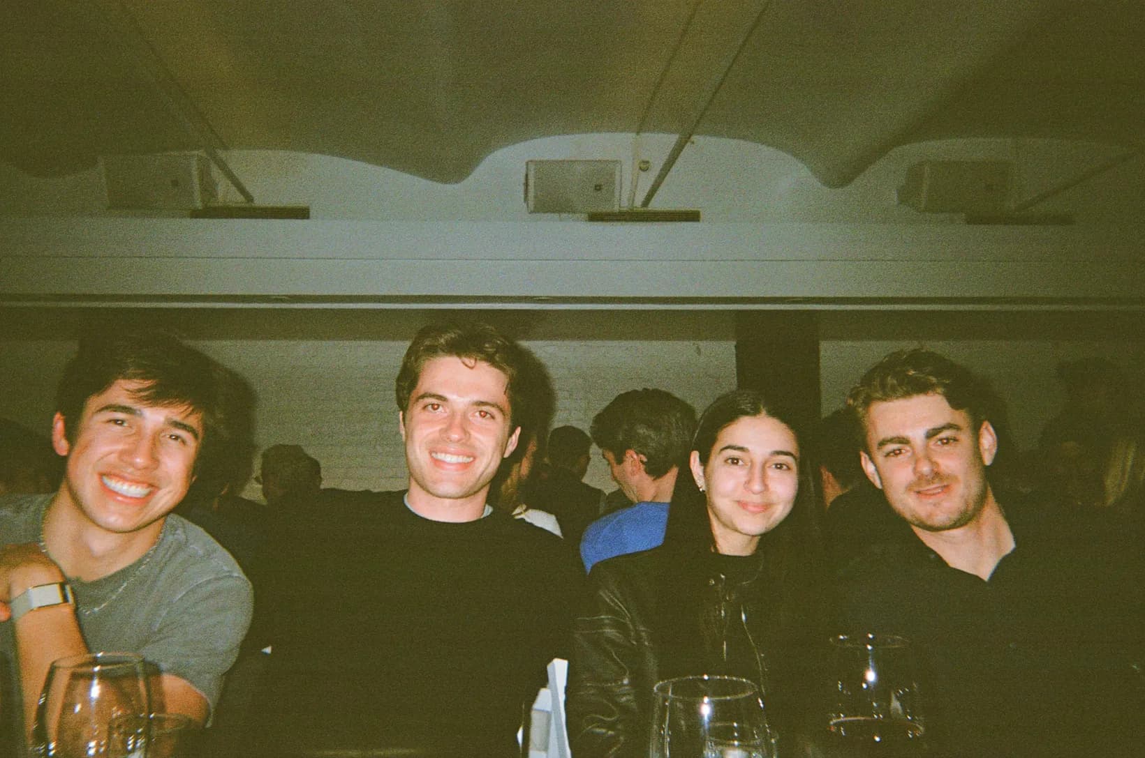Rogo teammates smiling around a table at a team dinner