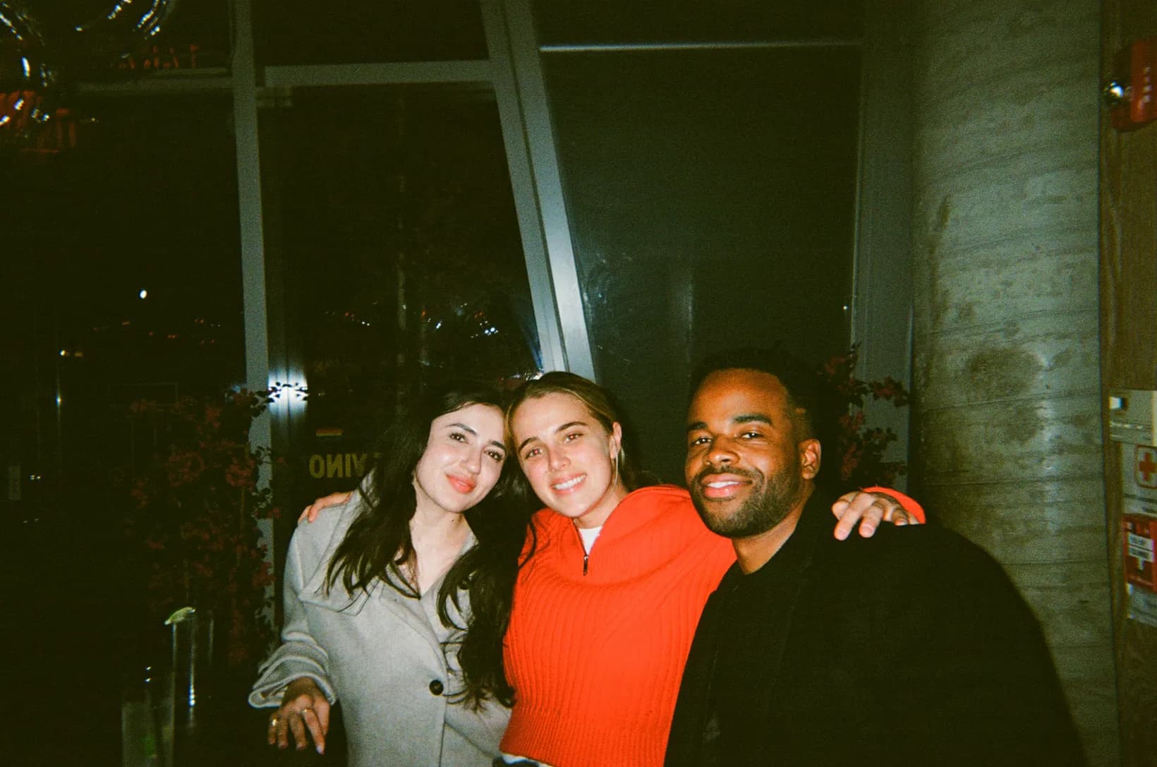 Three Rogo teammates smiling arm in arm at a team evening